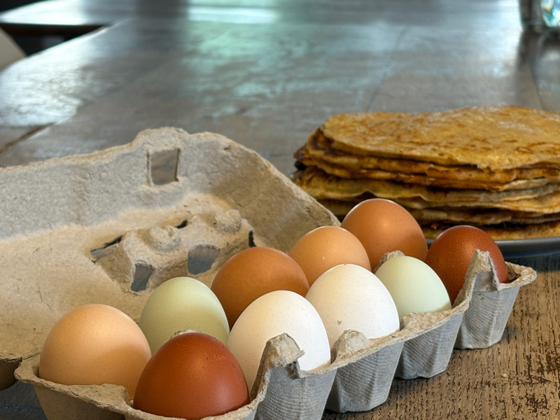 Colorful eggs in a box on the kitchen table
