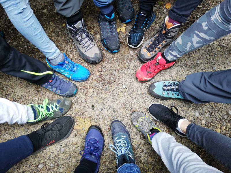 Kinderfüße in Wanderschuhen bildeneinen Kreis